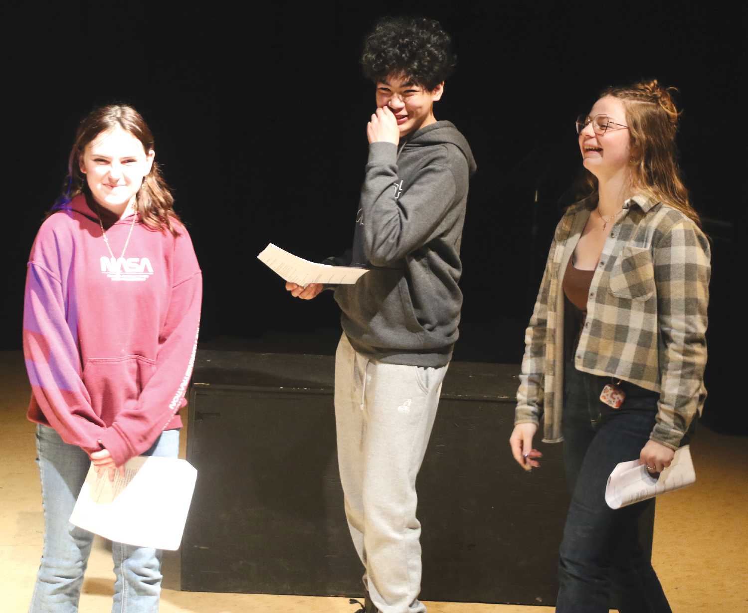 From left: Isabelle Tilley, Cristoffe Deangkinay, and Julia McConnell practicing a play on Friday for the regional drama festival.